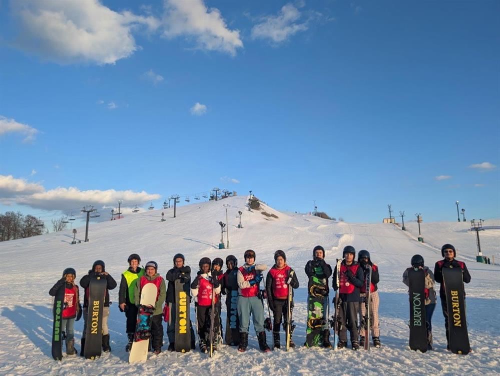   group of Western students with their skis and snowboards